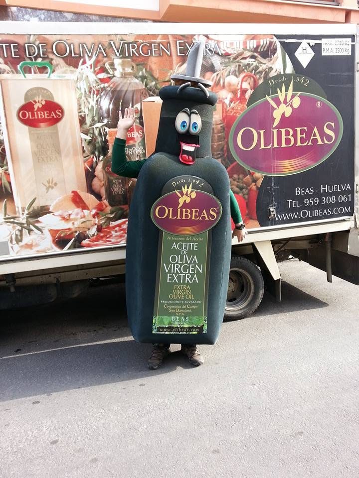 Disfraz con forma de botella de aceite junto a un camión